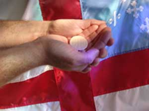 Hands with Communion Wafer and Episcopal Flag